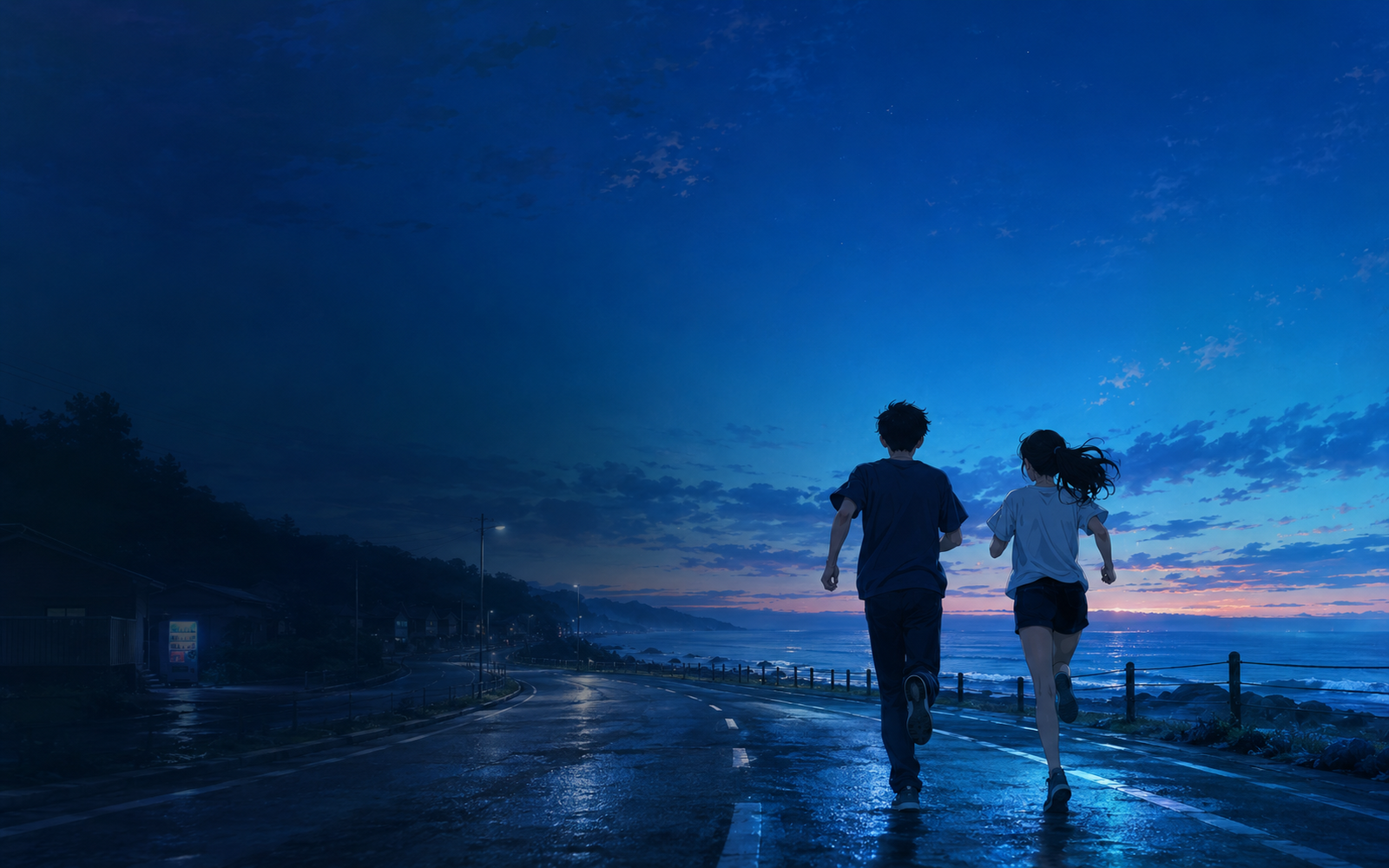 夜明け前の海沿いを走る二人